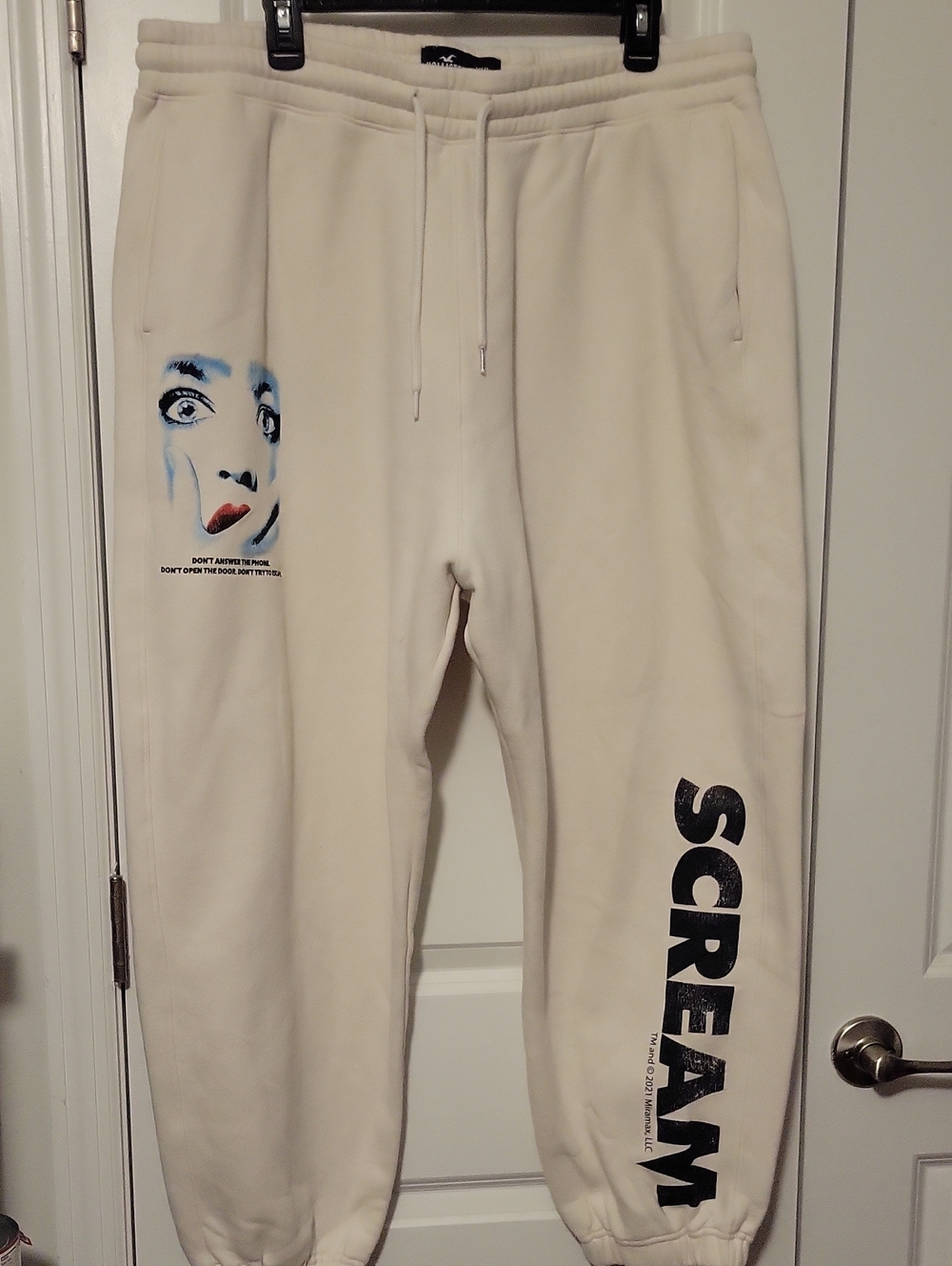 Hollister Cream Sweatpants with Black 'SCREAM' Leg Print and Blue Face Graphic